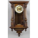 A late 19th century stained walnut and mahogany cased Vienna style wall clock,