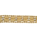 A woven bracelet with cultured pearl highlights.Stamped 14K.Length 18cms.