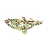 An early 20th century Art Nouveau 15ct gold enamel and split pearl brooch.Stamped 15ct.