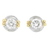 A pair of brilliant-cut diamond bi-colour stud earrings.Estimated total diamond weight 0.20ct.Posts