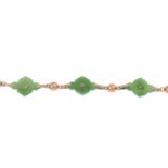 An early 20th century gold nephrite jade and split pearl bracelet.Length 18cms.