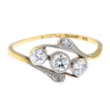 An early 20th century 18ct gold diamond three-stone crossover ring.Estimated total diamond weight