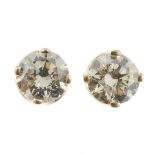 A pair of diamond single-stone stud earrings.Estimated total diamond weight 0.40ct,