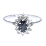 A sapphire and diamond cluster ring.Estimated total diamond weight 0.10ct.Ring size M1/2.
