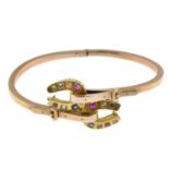 A bangle, with diamond ruby and sapphire horseshoe terminals.Foreign marks.