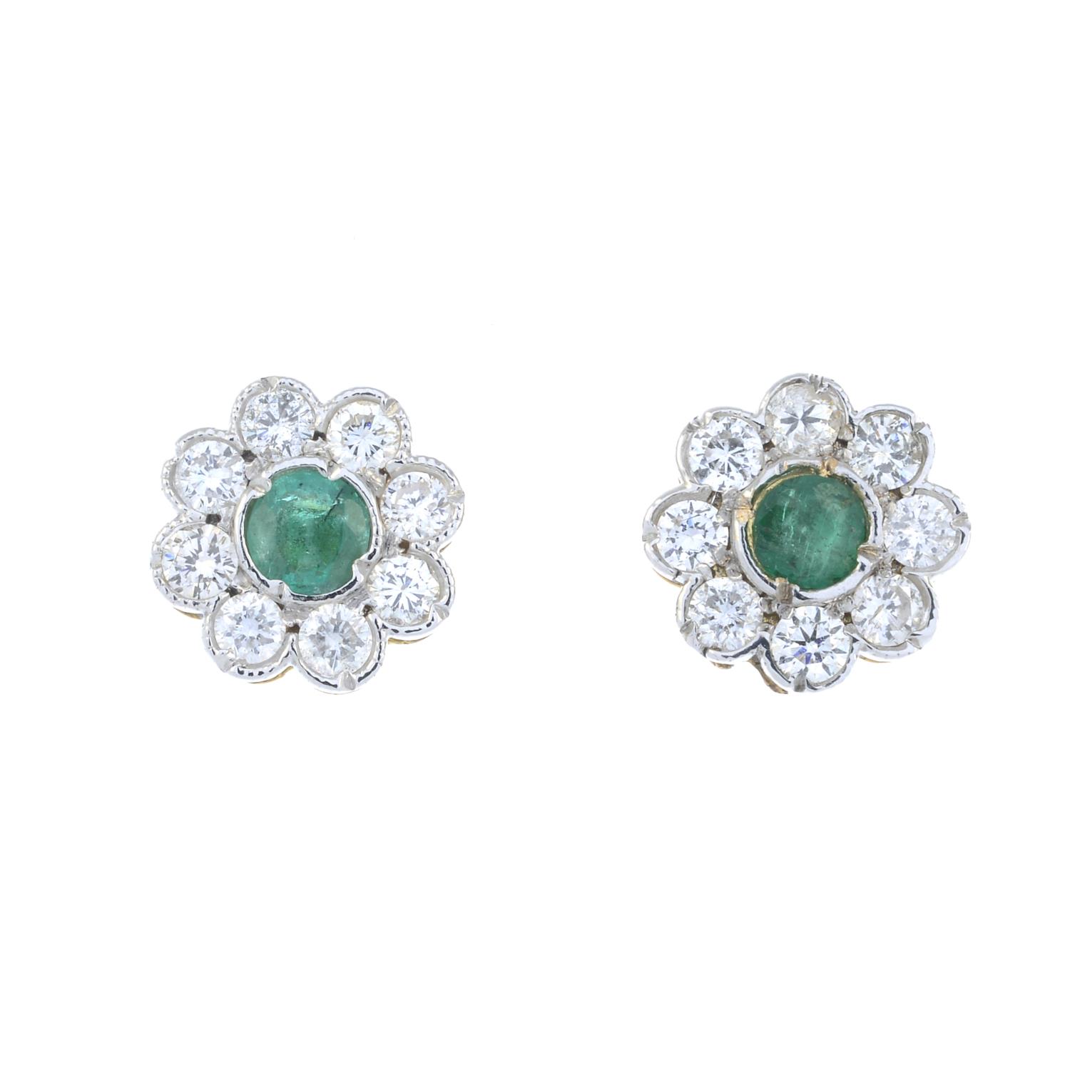 A pair of emerald and brilliant-cut diamond floral cluster earrings.Estimated total diamond weight