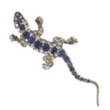 A sapphire and rose-cut diamond lizard brooch, with ruby eyes.Length 5.5cms.