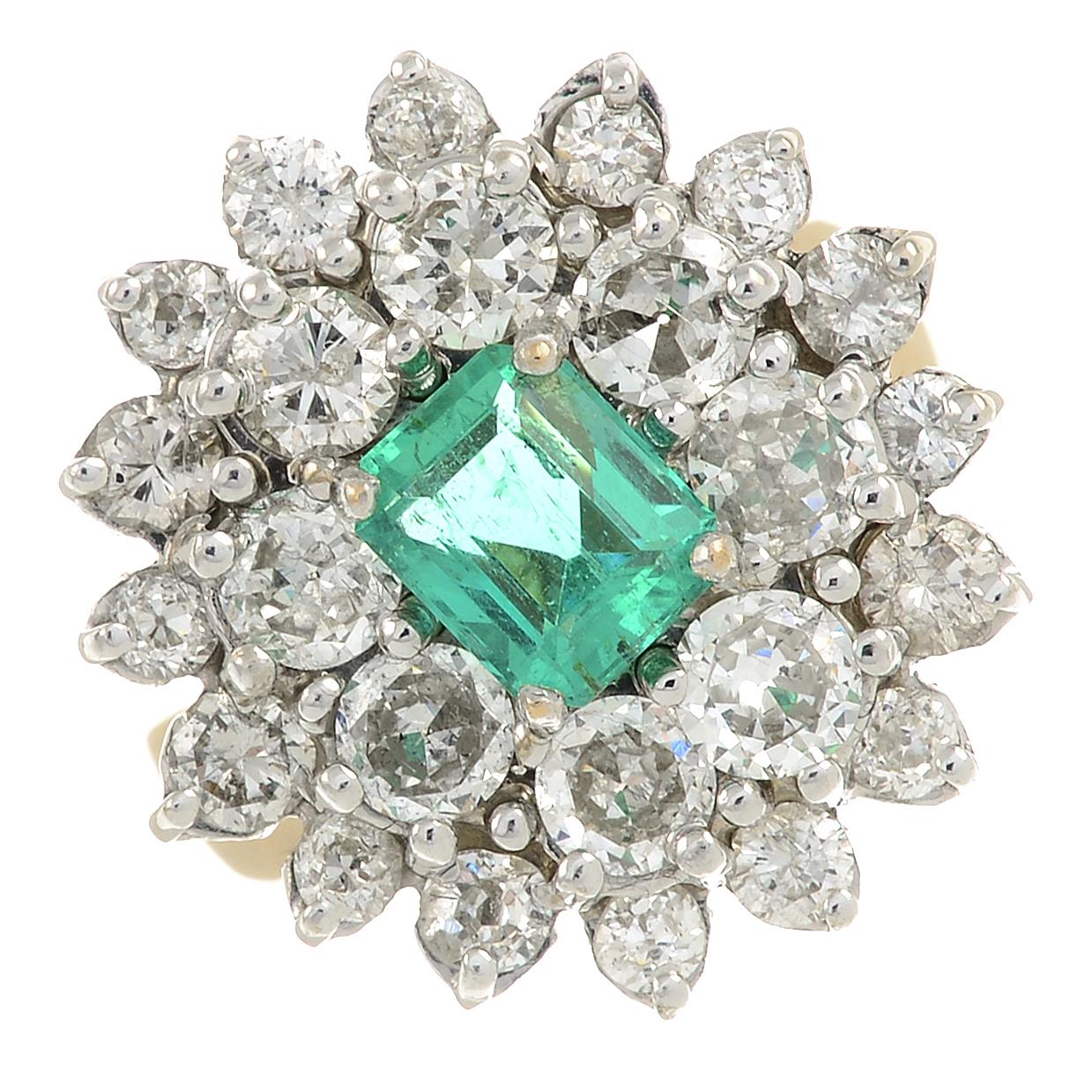 An emerald and circular-cut diamond cluster ring.Emerald calculated weight 0.84ct,