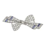 A mid 20th century platinum circular-cut diamond and sapphire bow brooch.