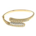 A brilliant-cut diamond asymmetric bangle,