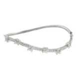 A diamond floral cluster bangle.Total diamond weight 11.80cts,