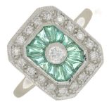 A platinum emerald and brilliant-cut diamond geometric cluster ring.