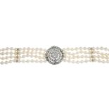 A four-row cultured pearl bracelet, with old-cut diamond cluster enhancer.