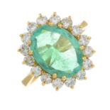 An 18ct gold emerald and brilliant-cut diamond cluster ring.Emerald calculated weight 2.88cts,