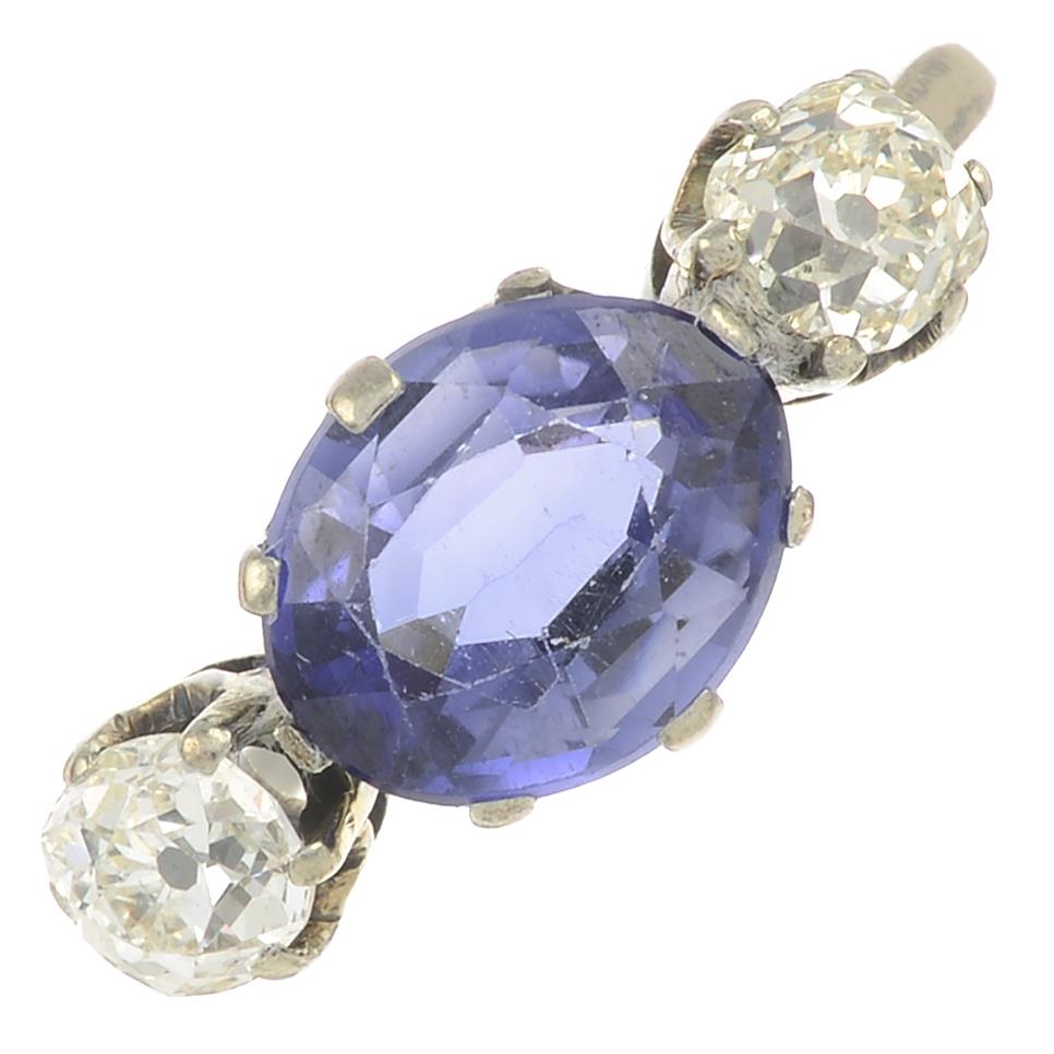 A sapphire and old-cut diamond three stone ring.Sapphire calculated weight 2.30cts,