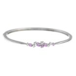 An 18ct gold pink sapphire and brilliant-cut diamond bangle.Estimated total diamond weight 0.20ct,
