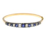 A late 19th century gold sapphire and old-cut diamond bangle.Estimated total diamond weight