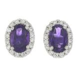 A pair of 18ct gold amethyst and brilliant-cut diamond cluster earrings.Total amethyst weight