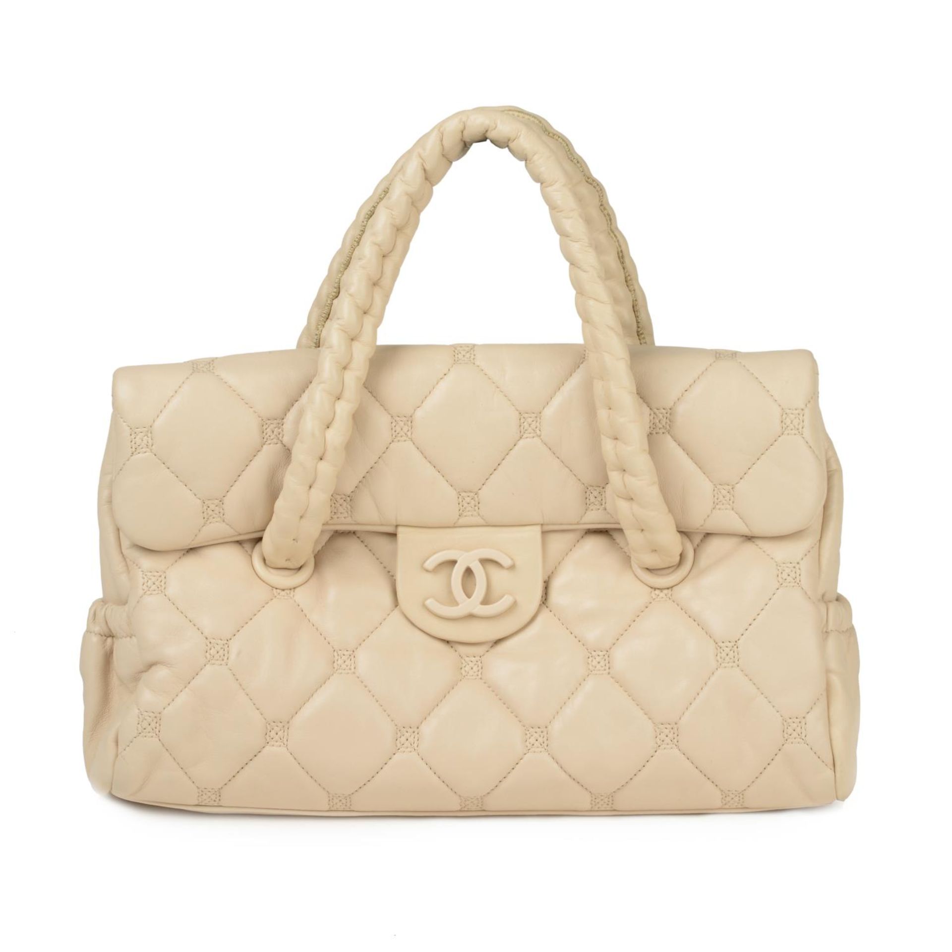 CHANEL - a pale quilted leather Hidden Chain handbag.