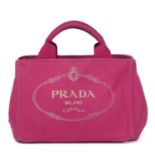 PRADA - a pink canvas handbag.