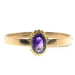 An early 20th century 15ct gold amethyst hinged bangle.Calculated amethyst weight 7.44cts,