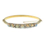 An opal and old-cut diamond hinged bangle.Opal weight 3.54cts.Estimated total diamond weight
