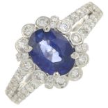 A sapphire and brilliant-cut diamond cluster ring.Sapphire weight 1.79cts.Total diamond weight