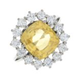 A yellow sapphire and brilliant-cut diamond cluster ring.Yellow sapphire calculated weight 6.62cts,