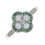 A platinum emerald and brilliant-cut diamond dress ring.Total emerald weight 0.20ct.Total diamond