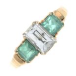 A baguette-cut diamond and emerald three-stone ring.Estimated diamond weight 0.60ct,