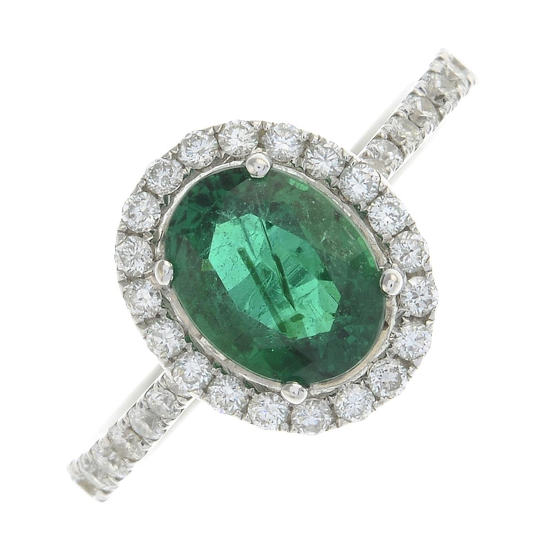 An 18ct gold emerald and brilliant-cut diamond dress ring.Emerald weight 1.26cts.Total diamond