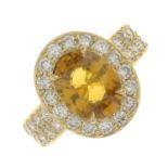 A yellow sapphire and diamond cluster ring.Sapphire weight 3cts.Estimated total diamond weight
