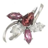 An 18ct gold pink tourmaline and diamond dress ring.Estimated total diamond weight 0.60ct,
