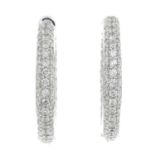 A pair of 18ct gold pave-set diamond hoop earrings.Total diamond weight 2.02cts,