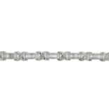 An 18ct gold baguette-cut diamond line bracelet.Total diamond weight 2.75cts,