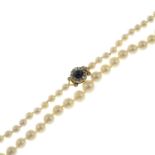 A cultured pearl necklace with sapphire and rose-cut diamond clasp.Cultured pearl diameters 7.2 to