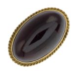 An early 20th century 15ct gold garnet cabochon brooch.Estimated dimensions of garnet 25 by