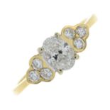 An 18ct gold oval and brilliant-cut diamond dress ring.Principal diamond with laser inscription GIA