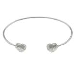 A bangle, with heart-shape and brilliant-cut terminals.Estimated total diamond weight 1ct,