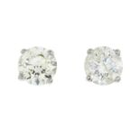 A pair of brilliant-cut diamond single-stone stud earrings.Total diamond weight 1.10cts,