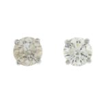 A pair of brilliant-cut diamond single-stone earrings.Total diamond weight 1.10cts,