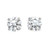 A pair of brilliant-cut diamond stud earrings.Total diamond weight 0.75ct,