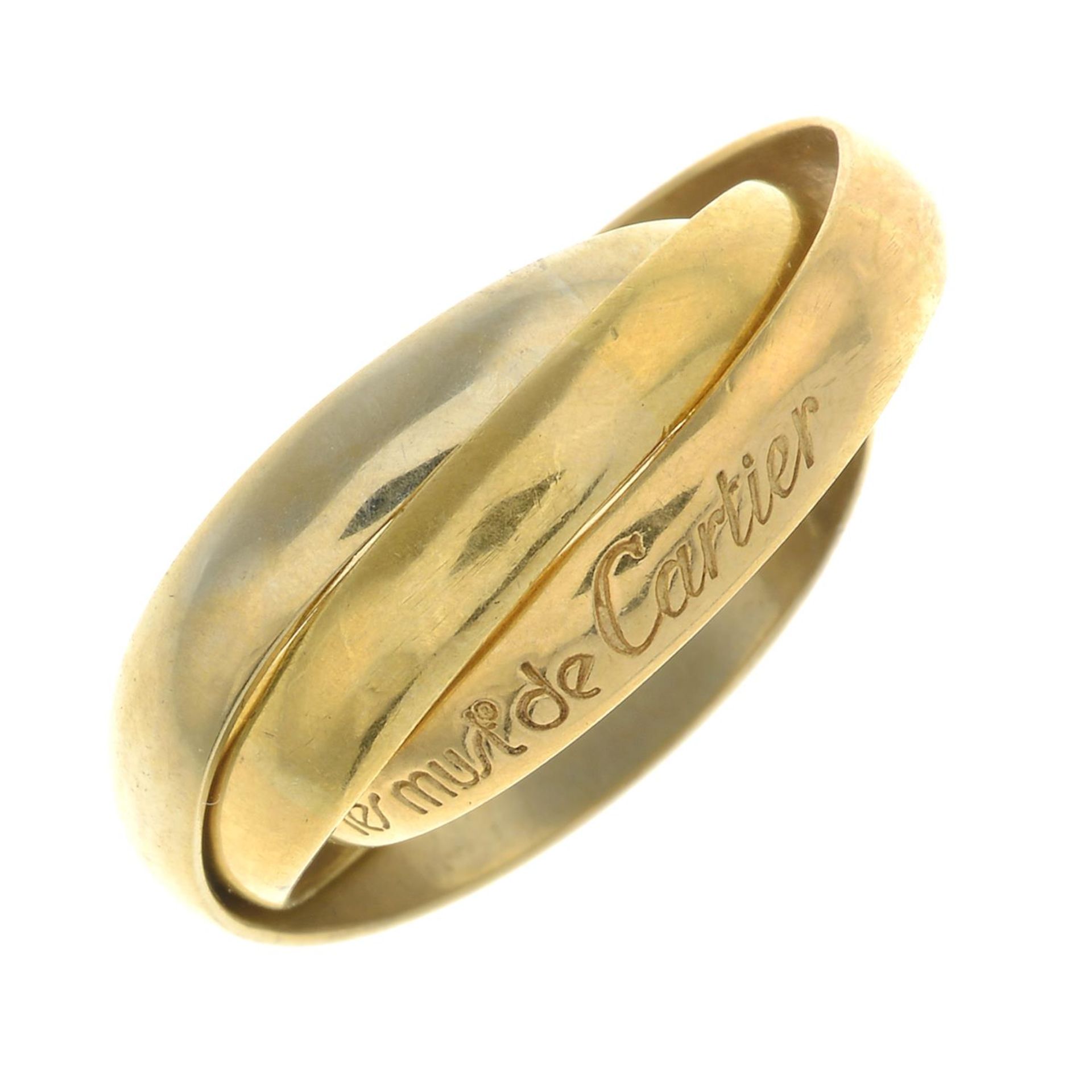 A 'Les Must de Cartier Trinity' ring, by Cartier.Makers marks for Cartier.Stamped 750.Ring size N.