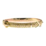 An early 20th century 9ct gold hinged bangle,