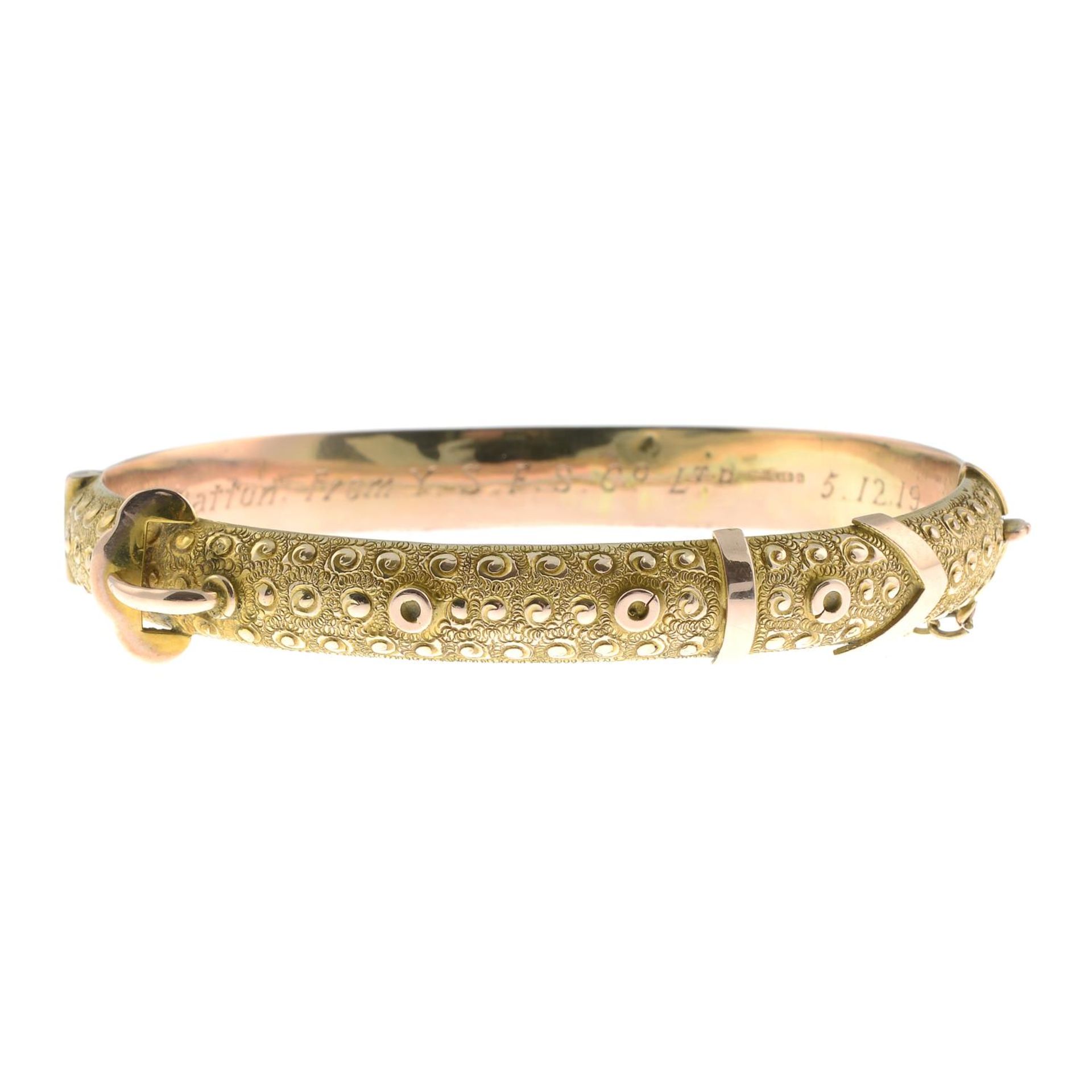 An early 20th century 9ct gold hinged bangle,