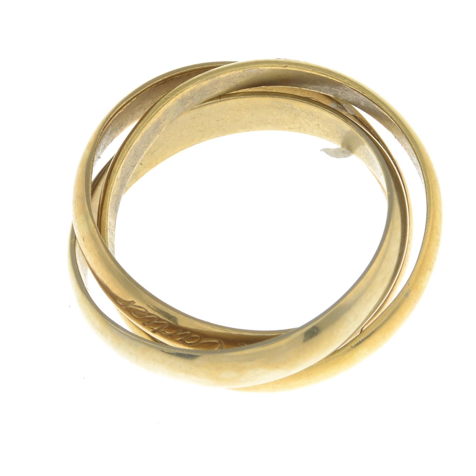 A 'Les Must de Cartier Trinity' ring, by Cartier.Makers marks for Cartier.Stamped 750.Ring size N. - Image 2 of 2