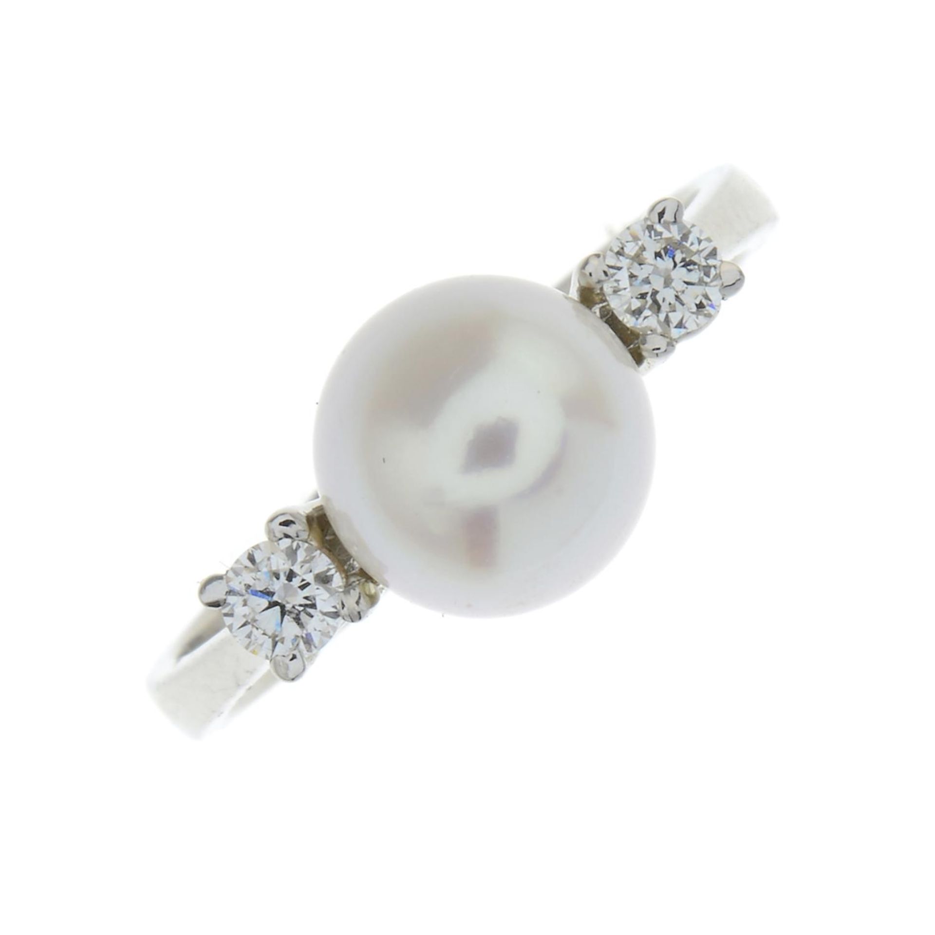 A cultured pearl and diamond three-stone ring.