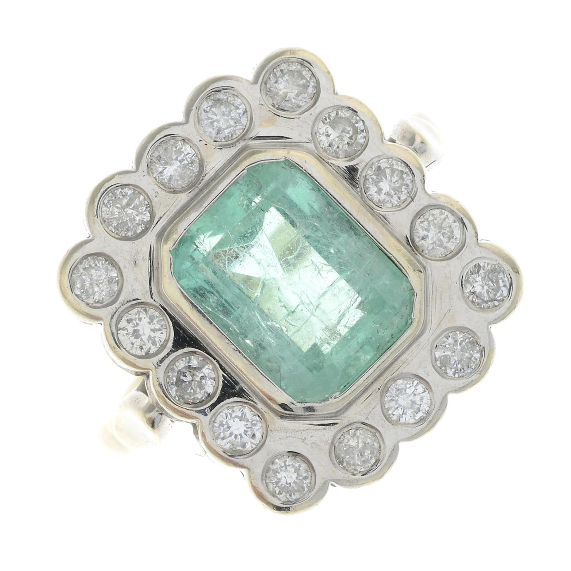 An emerald and diamond cluster ring.Emerald calculated weight 1.66cts,
