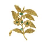 An 18ct gold emerald and diamond floral brooch.Estimated total diamond weight 0.30ct.Import marks