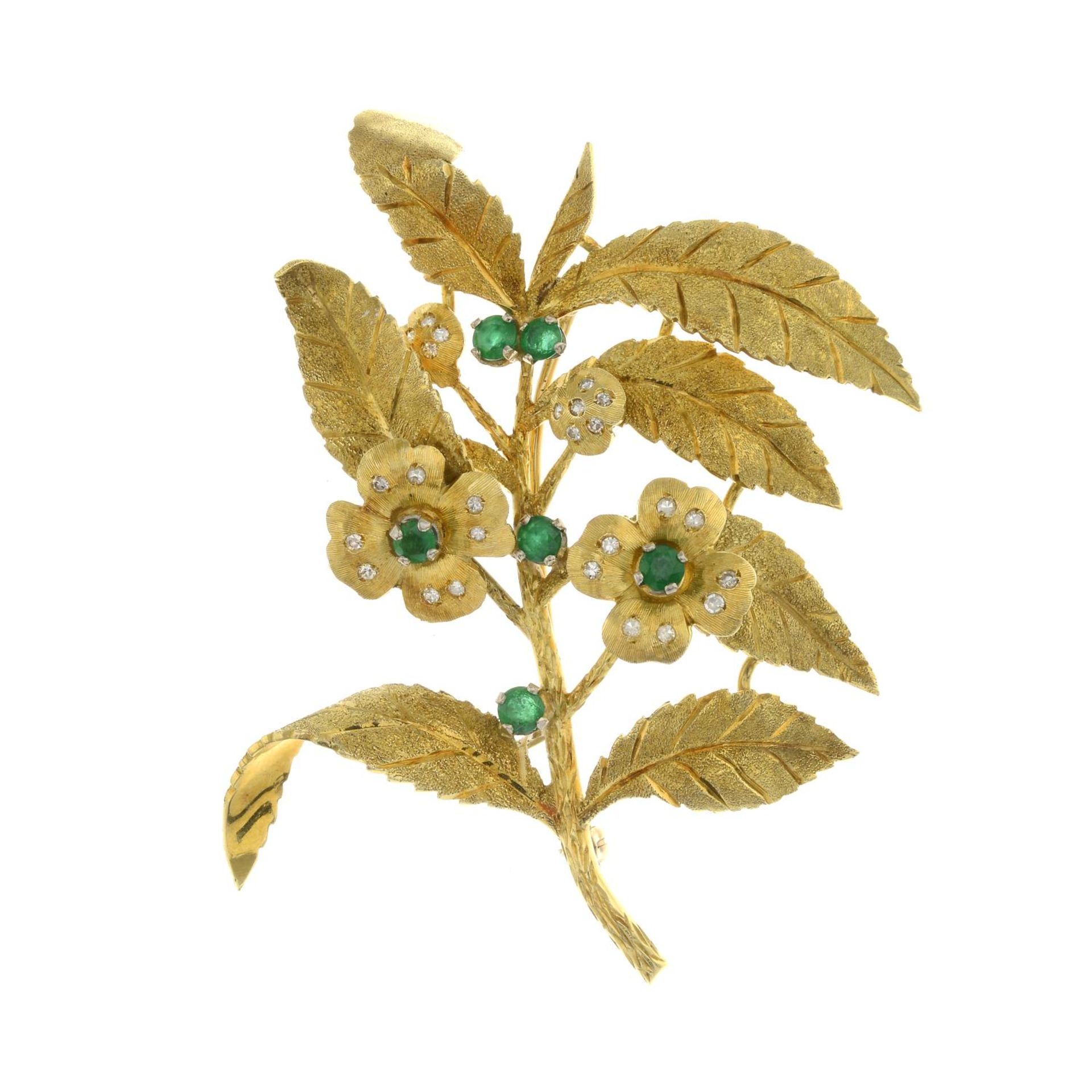 An 18ct gold emerald and diamond floral brooch.Estimated total diamond weight 0.30ct.Import marks